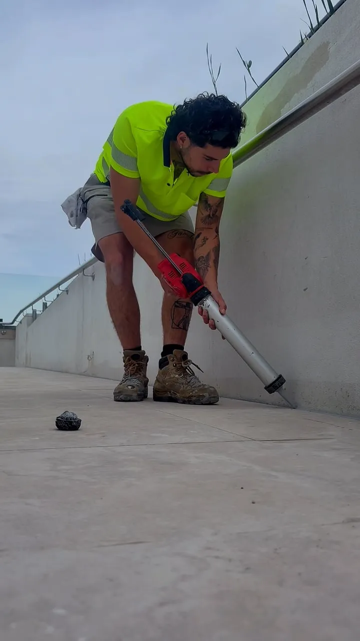 SR Joint Sealer technician in hi-vis sealing a concrete wall joint on a commercial project