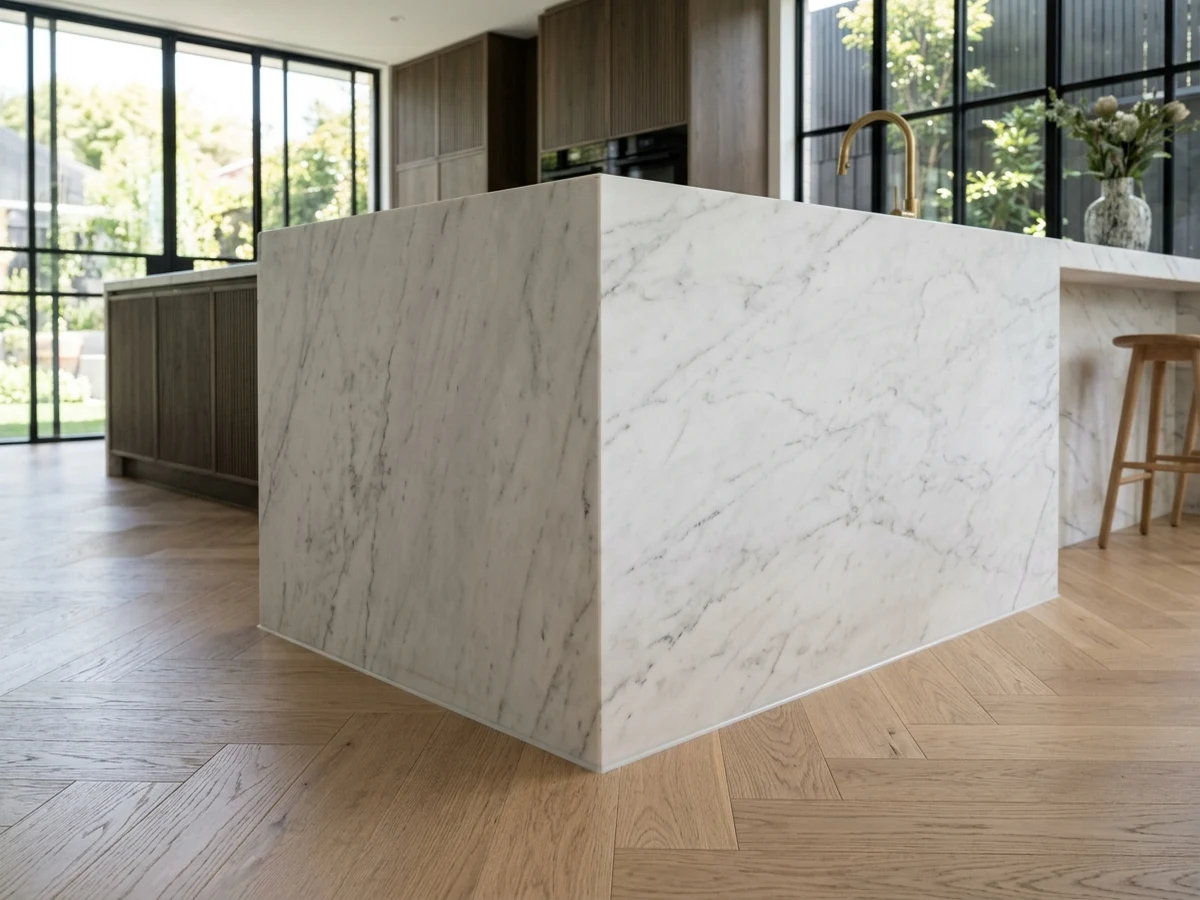 Seamless silicone joint between Calacatta marble island and herringbone floor – Internal Caulking Brisbane